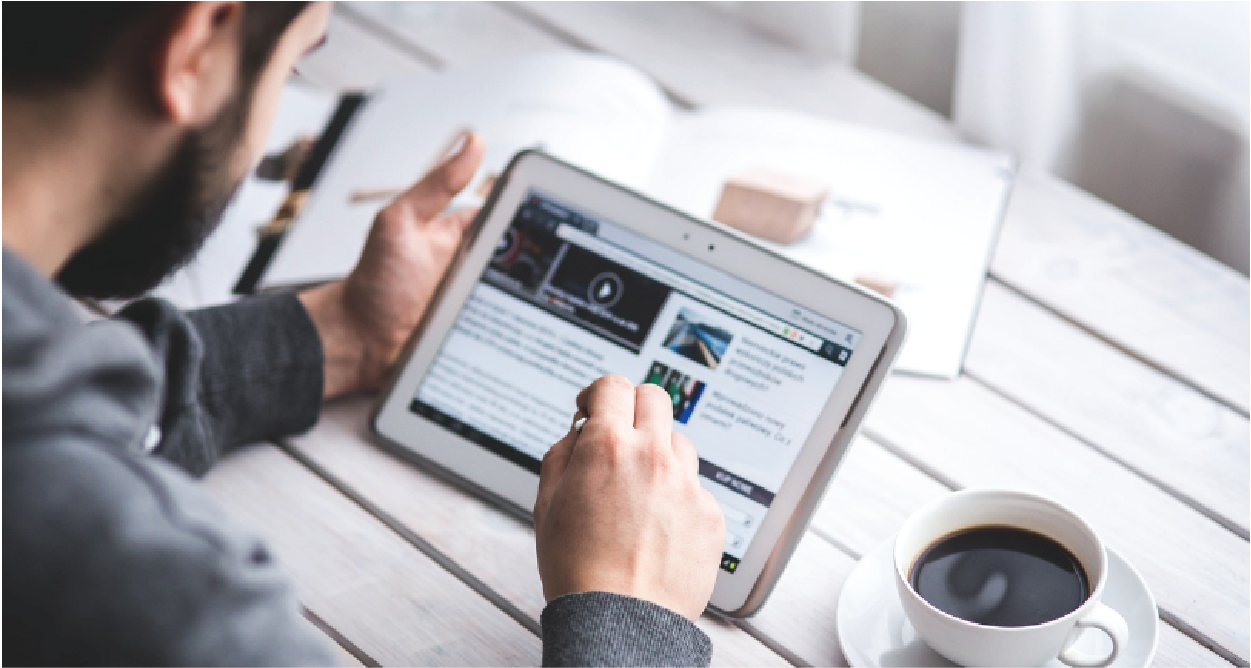 wide pic of man using tablet